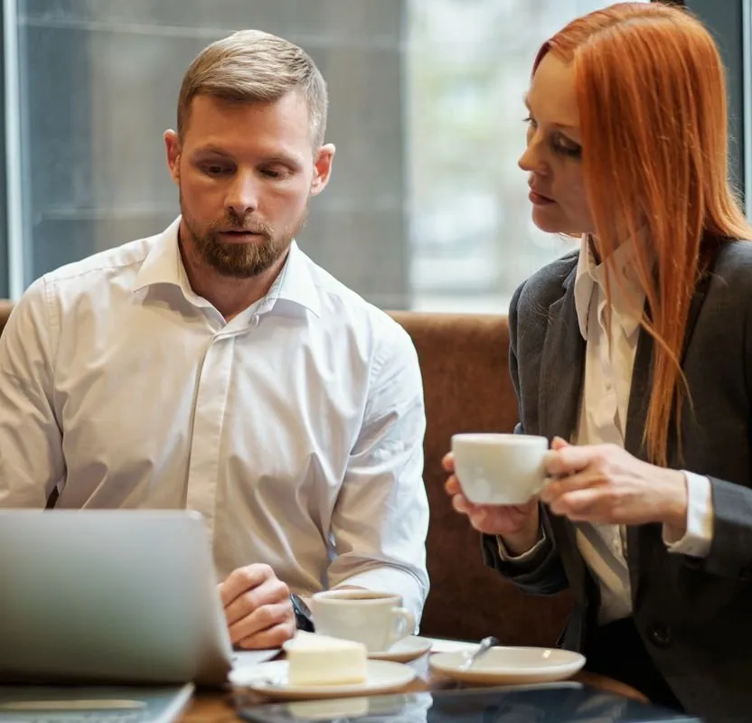 Discussion with a client over a laptop about a project's progress