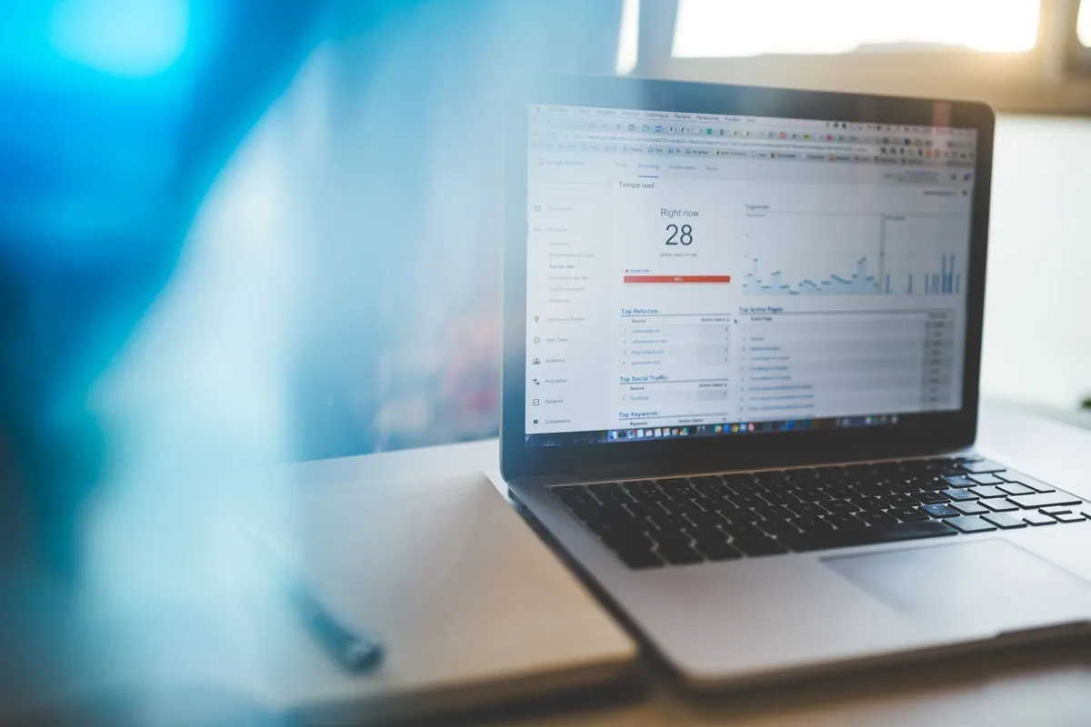 A laptop showing a website speed/performance graph on screen